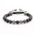 front 8mm macrame bracelet made with moss agate and matte black onyx